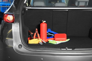 Set of car safety equipment in trunk, space for text