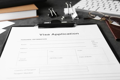 Photo of Visa application form for immigration and stationery on grey table, closeup