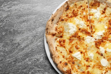 Tasty cheese pizza on grey table, top view. Space for text