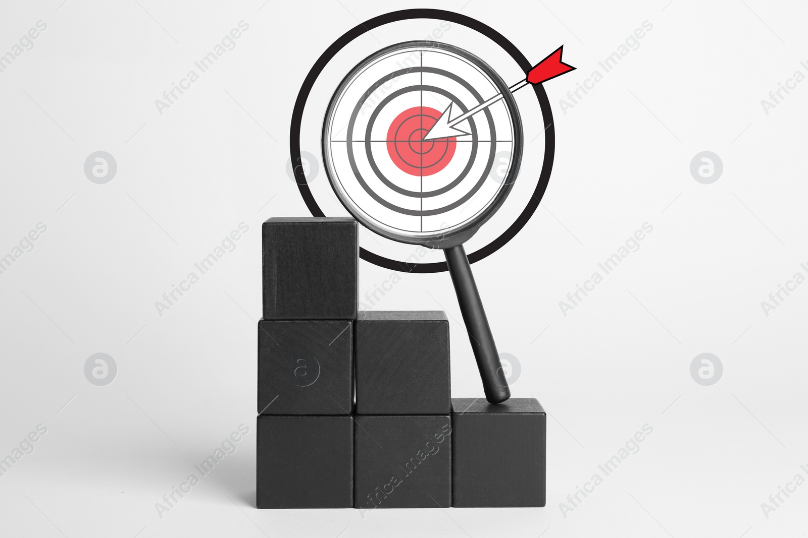 Image of Magnifying glass with illustration of target and arrow on black cubes against white background