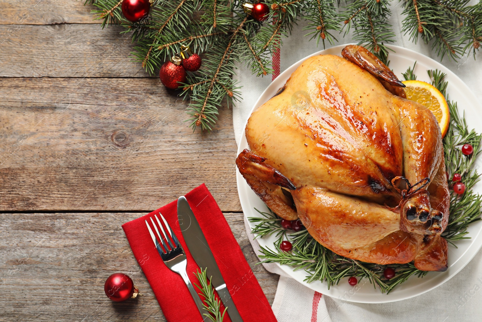 Photo of Cooked turkey with garnish served for Christmas dinner on table, flat lay. Space for text