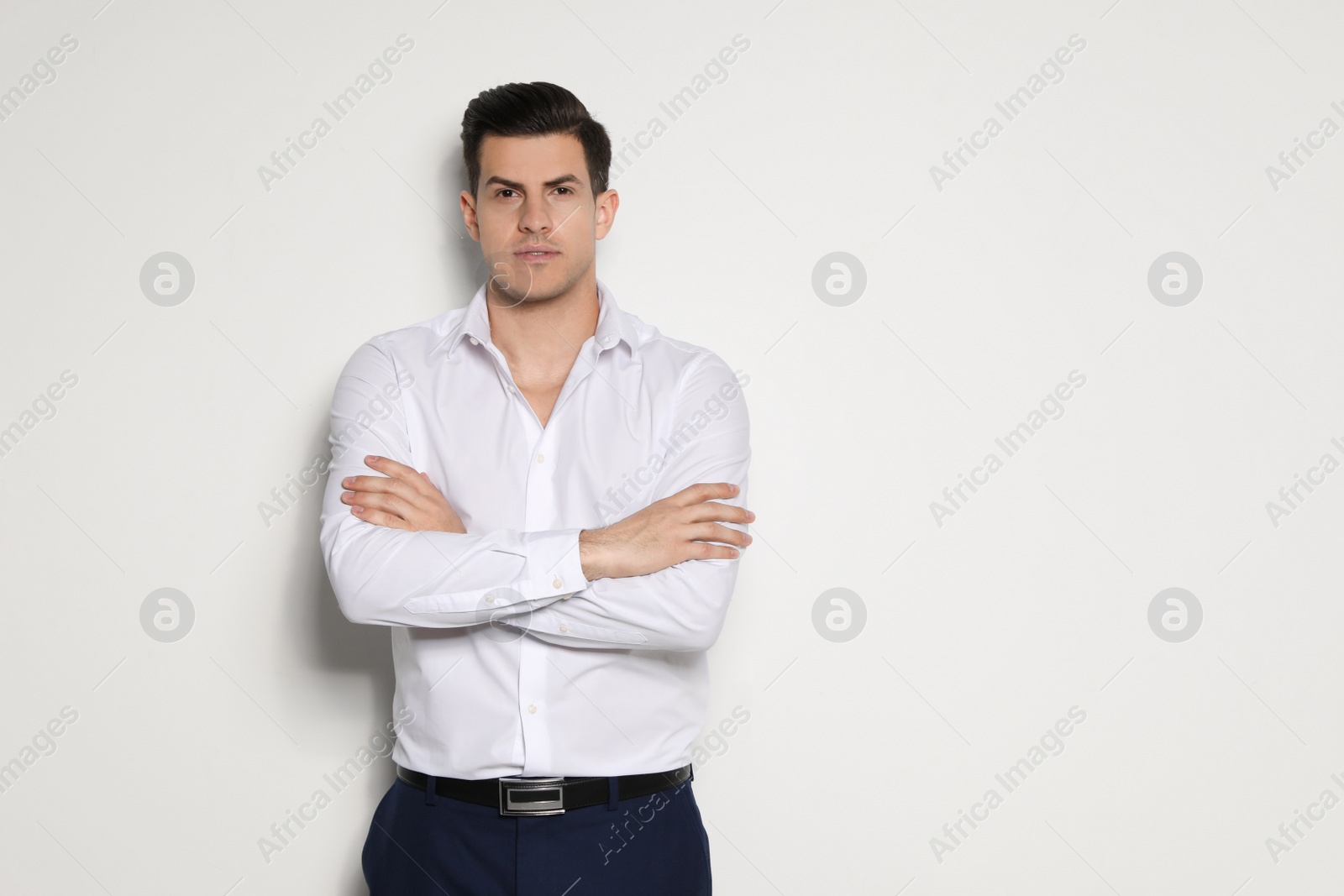 Photo of Portrait of handsome man on light background. Space for text