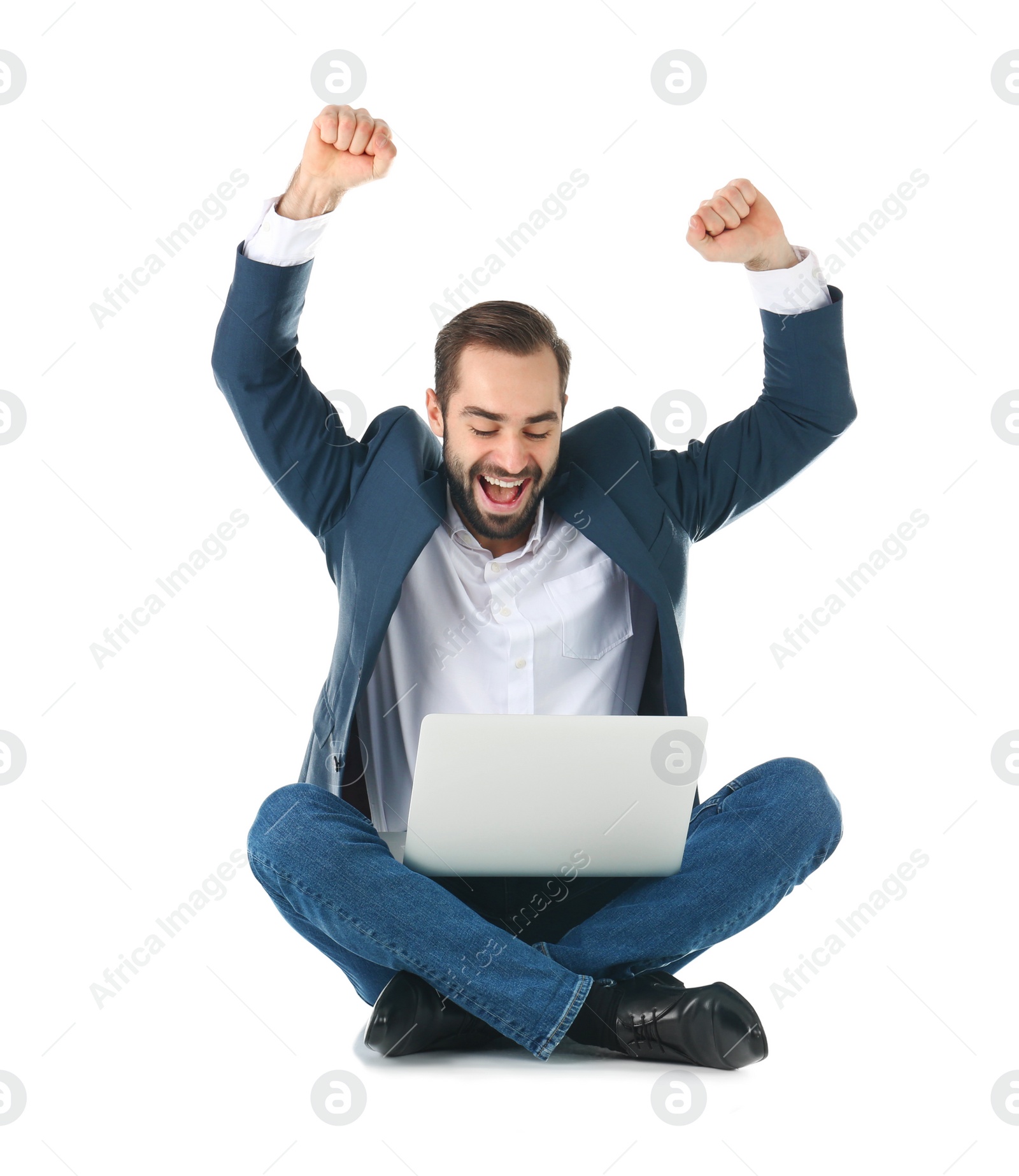 Photo of Emotional businessman in office wear with laptop celebrating victory on white background