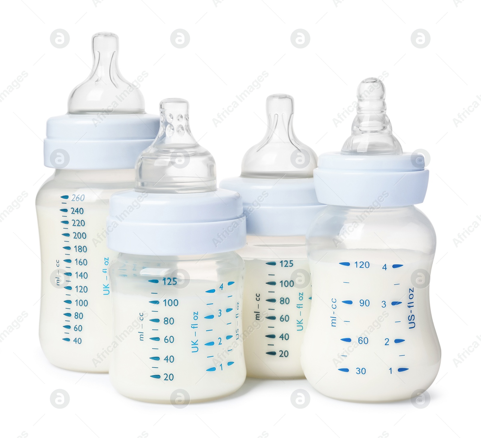 Photo of Many feeding bottles with infant formula on white background