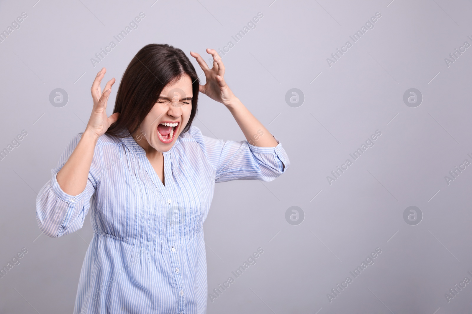 Photo of Portrait of stressed young woman on grey background. Space for text