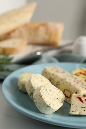 Photo of Tasty butter with herbs and spices on white table, closeup