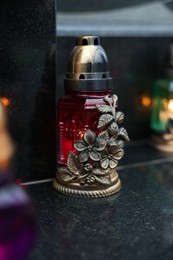 Photo of Grave light on granite surface at cemetery