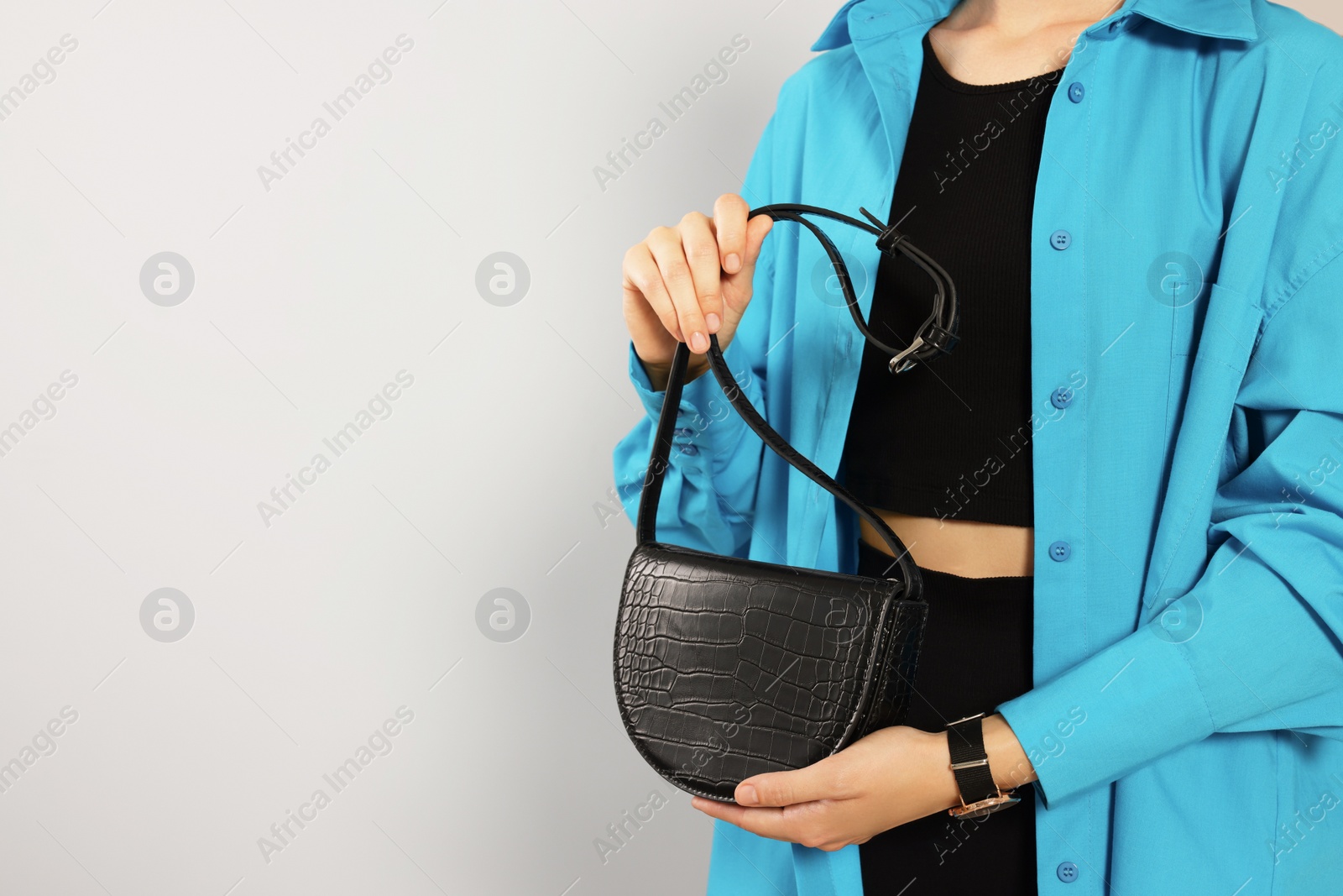 Photo of Woman with stylish bag on white background, closeup. Space for text