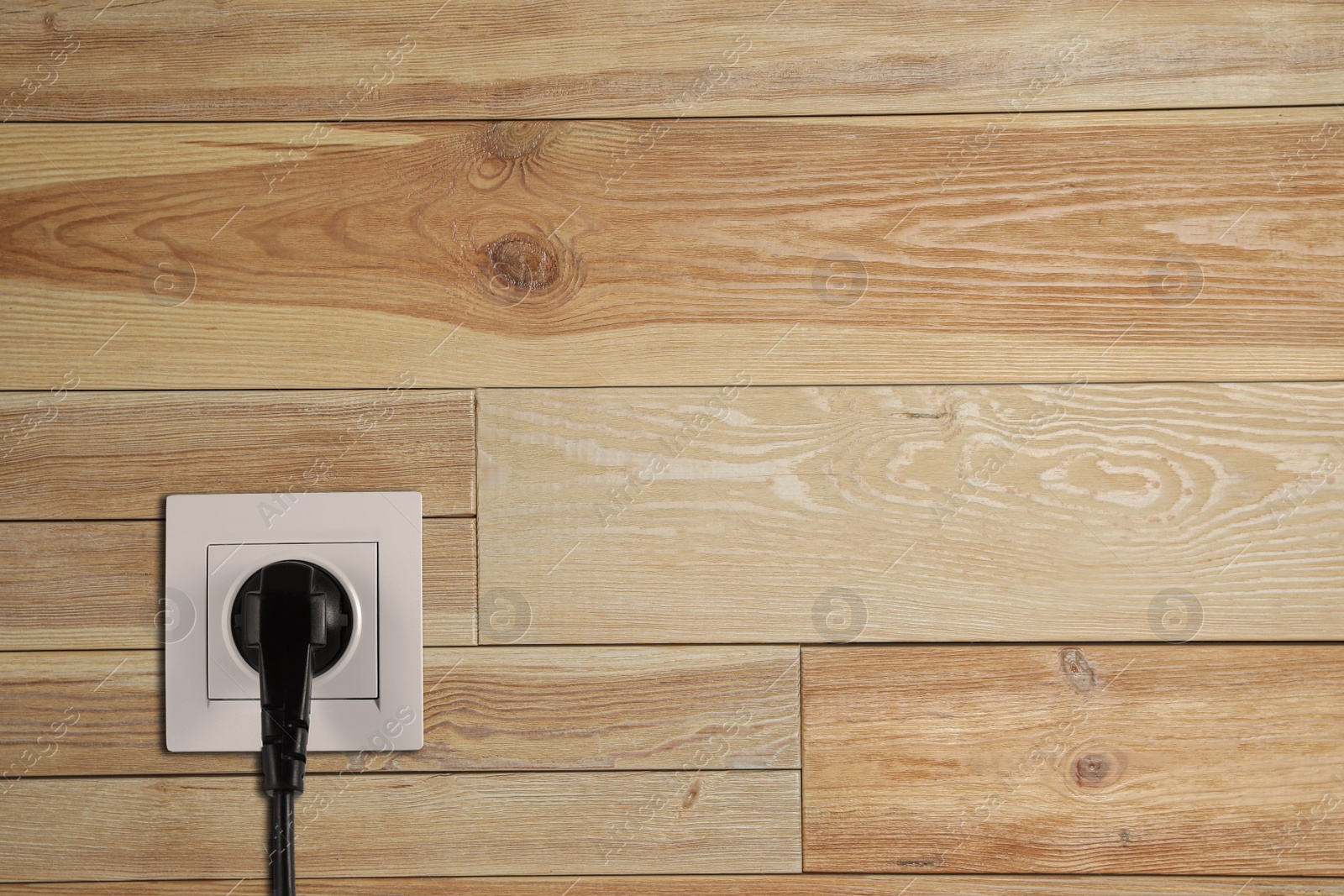 Wooden wall with power socket and inserted plug, space for text. Electrical supply Image of Wooden wall with power socket and inserted plug, space for text. Electrical supply