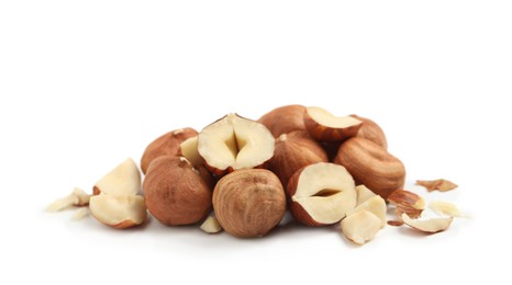Photo of Heap of tasty hazelnuts on white background