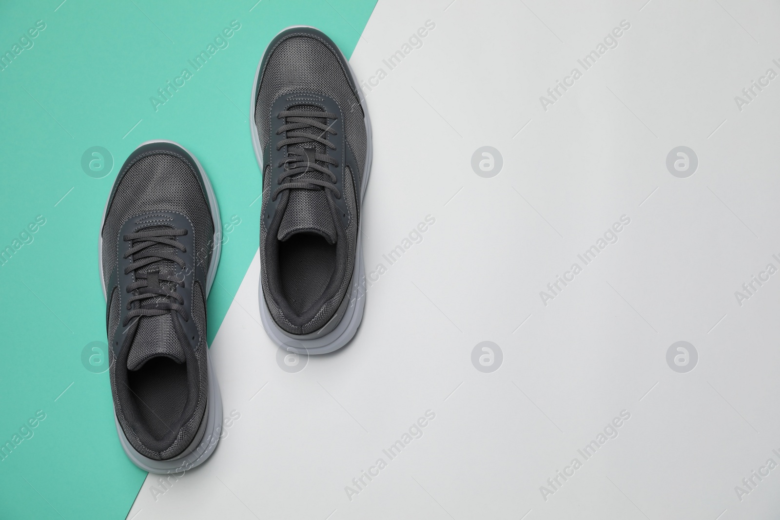 Photo of Pair of stylish sport shoes on color background, flat lay. Space for text