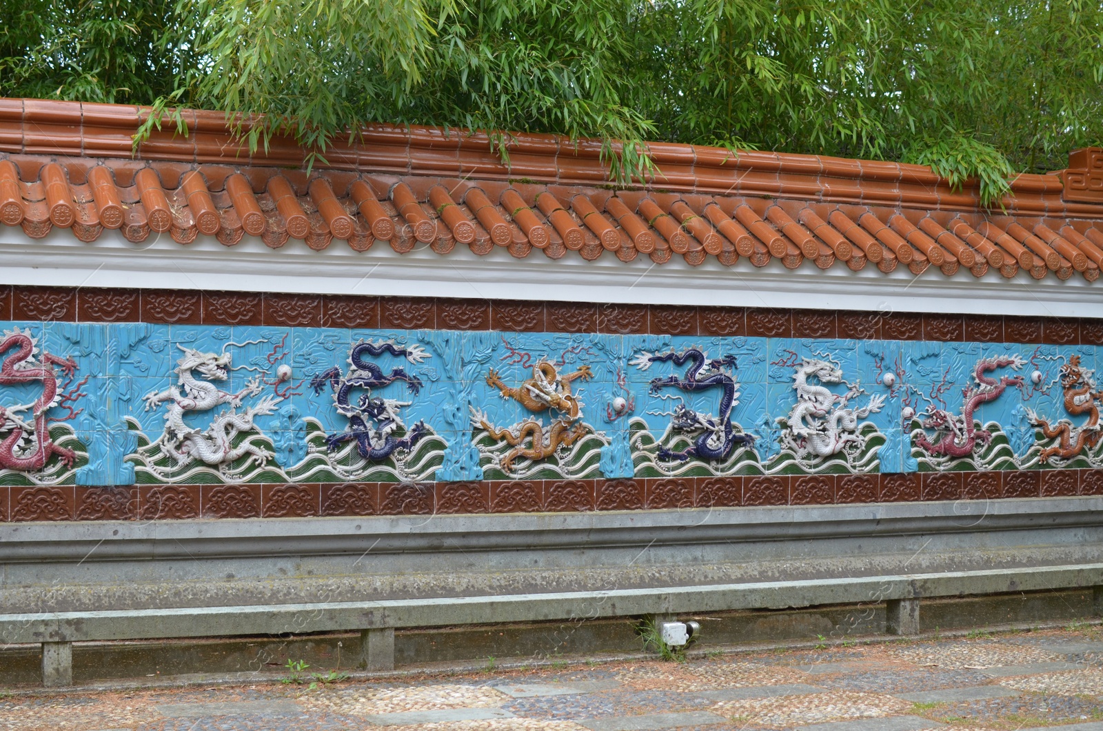 Photo of HAREN, NETHERLANDS - MAY 23, 2022: View of Nine-Dragon wall in Chinese garden
