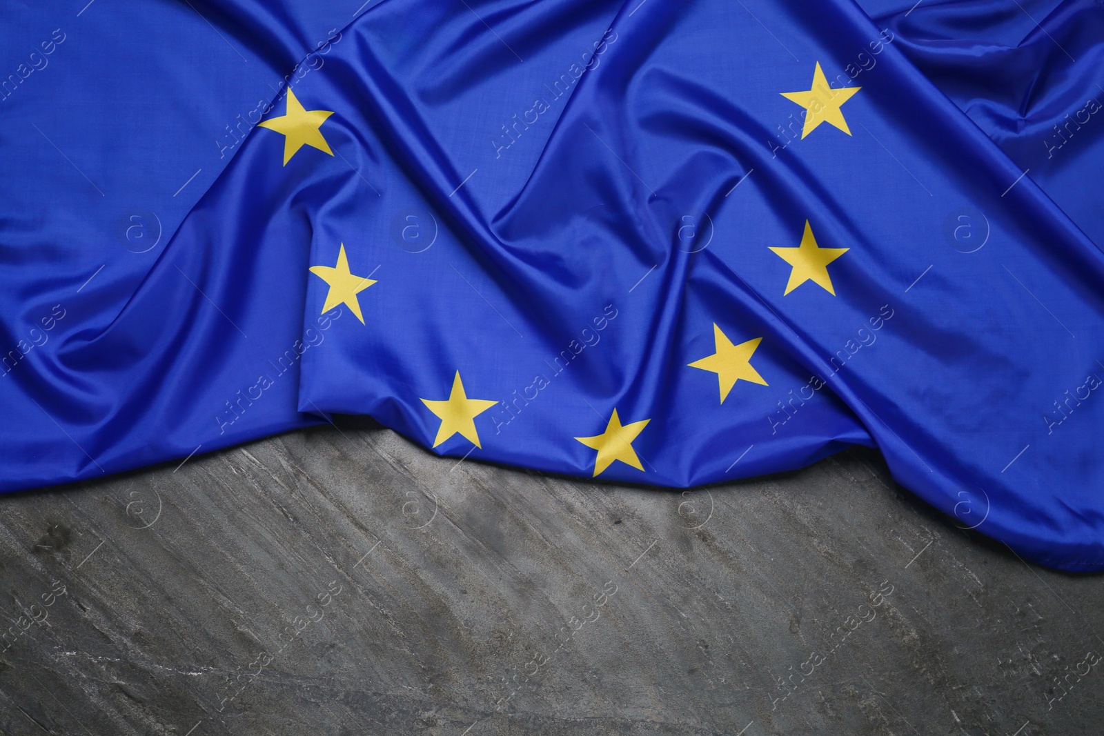 Photo of Flag of European Union on grey table, top view