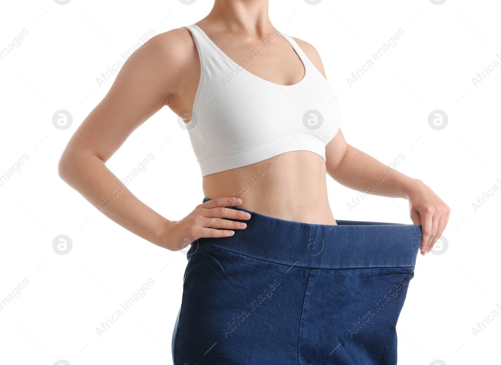 Photo of Young slim woman wearing oversized jeans on white background, closeup