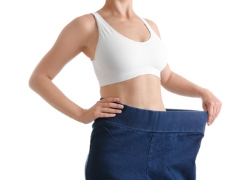 Photo of Young slim woman wearing oversized jeans on white background, closeup