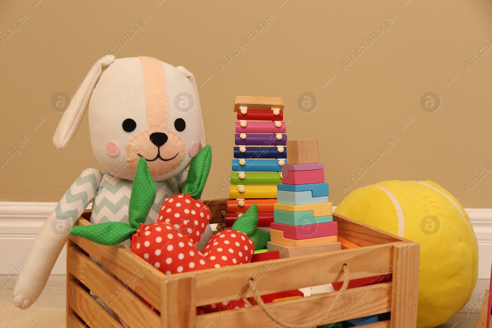 Photo of Set of different cute toys near beige wall