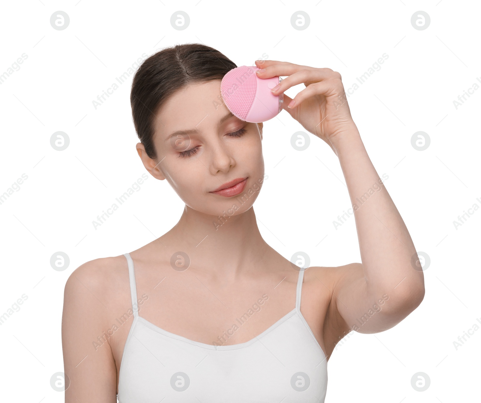 Photo of Washing face. Young woman with cleansing brush on white background