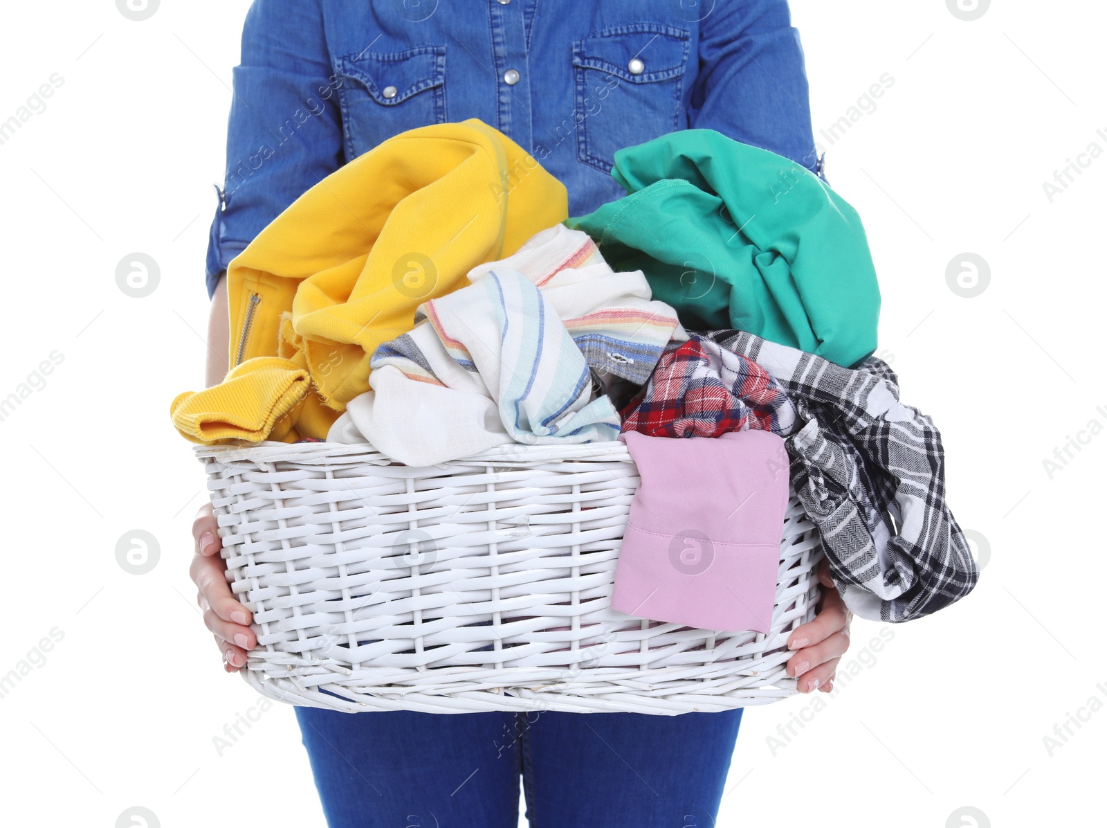 Photo of Woman holding laundry basket with dirty clothes on white background