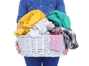 Photo of Woman holding laundry basket with dirty clothes on white background