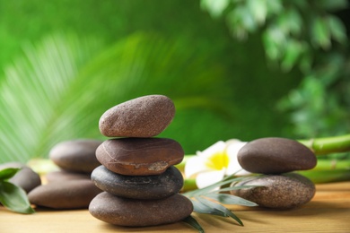 Photo of Composition with stones on table against blurred background. Zen concept