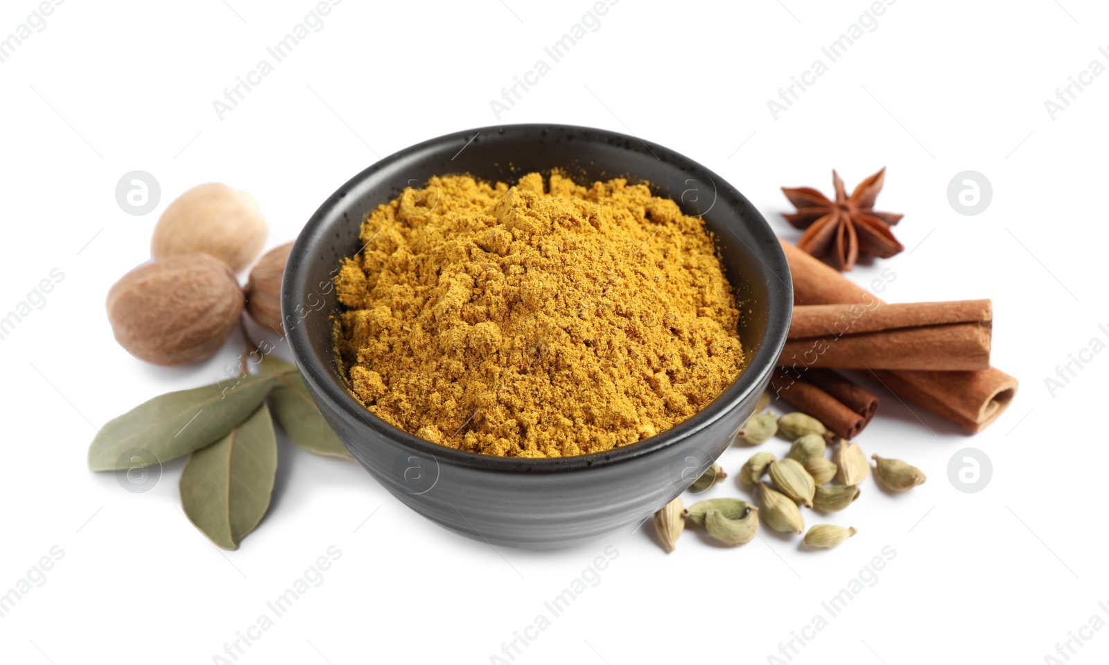 Photo of Dry curry powder in bowl and other spices isolated on white