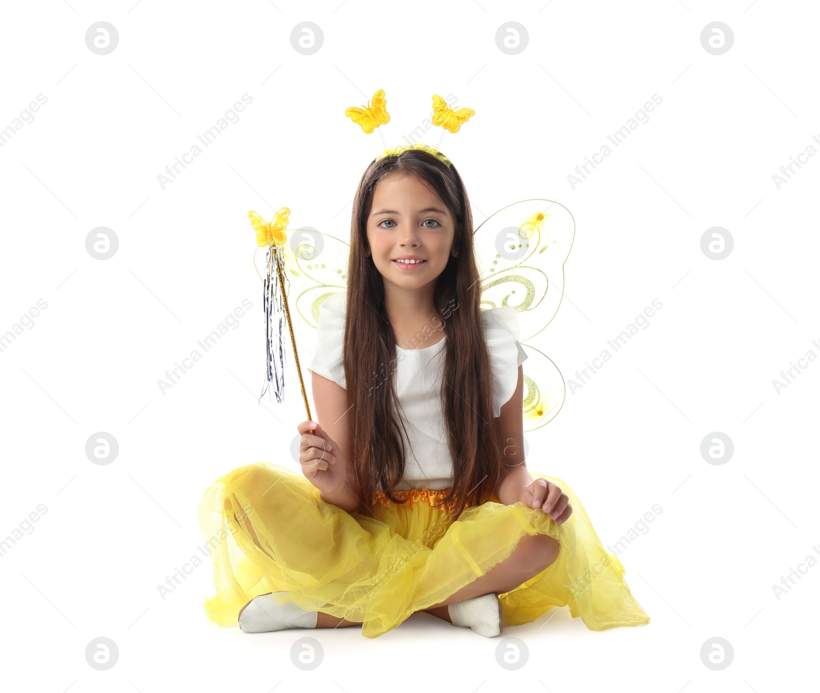 Photo of Cute little girl in fairy costume with yellow wings and magic wand on white background