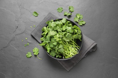 Photo of Bunch of fresh aromatic cilantro on grey table, flat lay