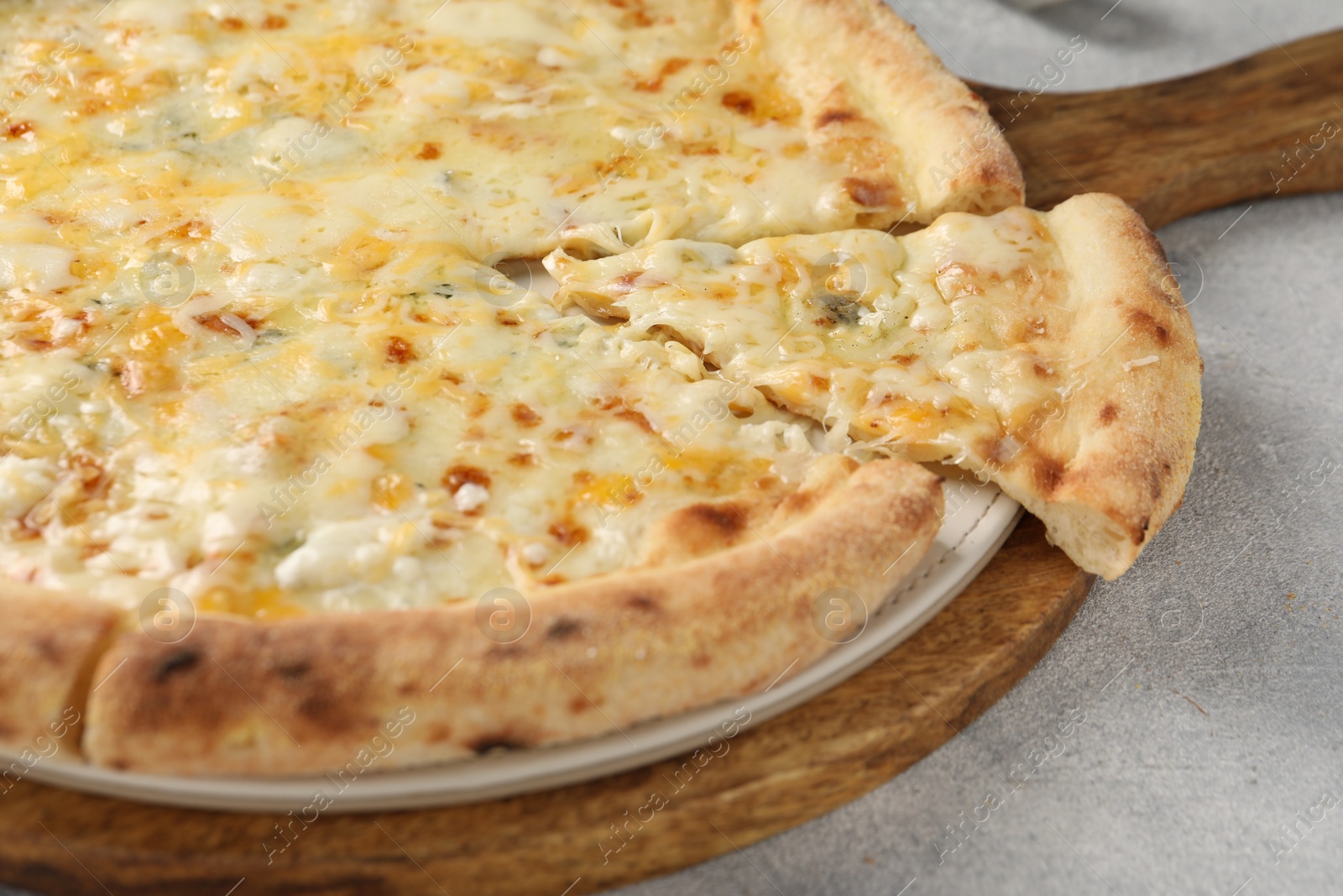 Photo of Delicious cheese pizza on light grey table, closeup