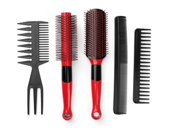 Photo of Set of hair brushes and combs isolated on white, top view