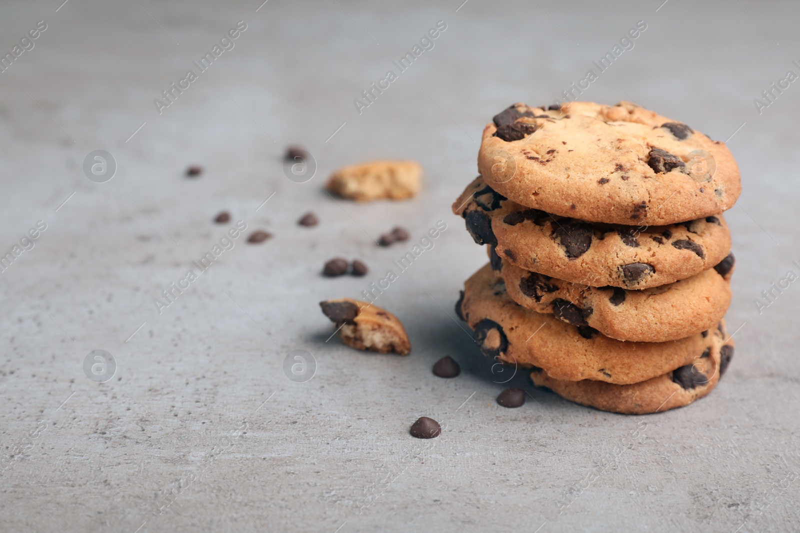 Photo of Stack of tasty chocolate cookies on gray table