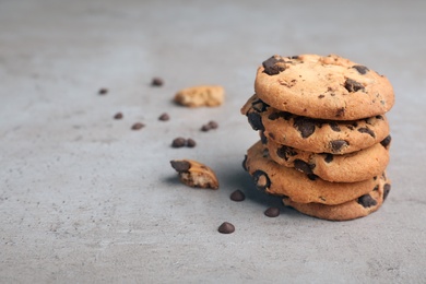 Photo of Stack of tasty chocolate cookies on gray table