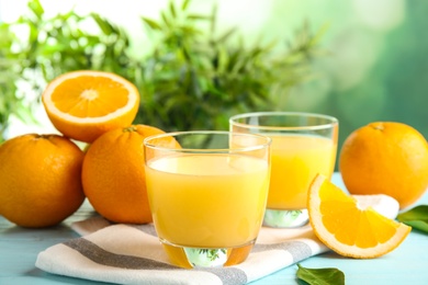 Composition with orange juice and fresh fruit on table