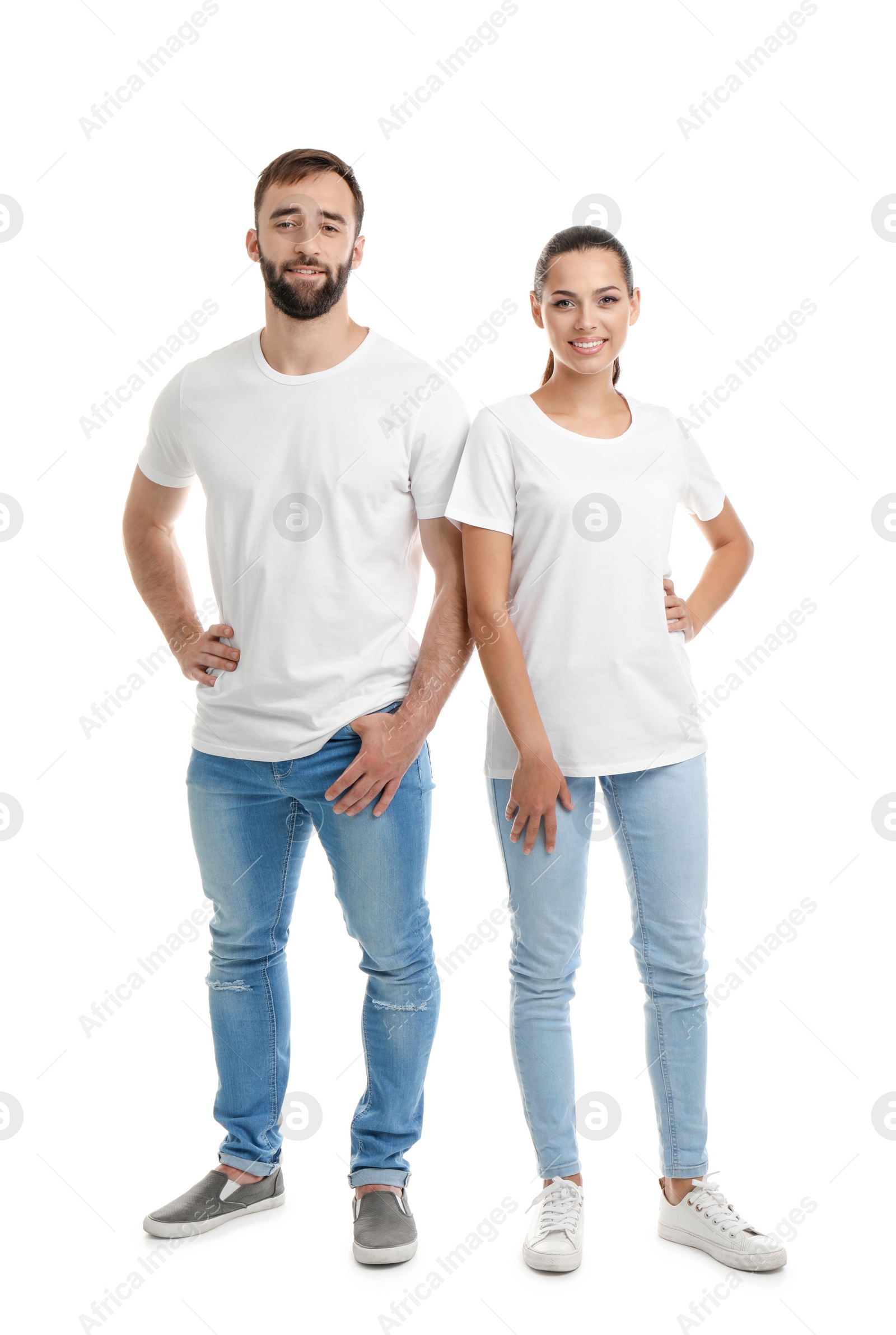 Photo of Young couple in t-shirts on white background. Mockup for design