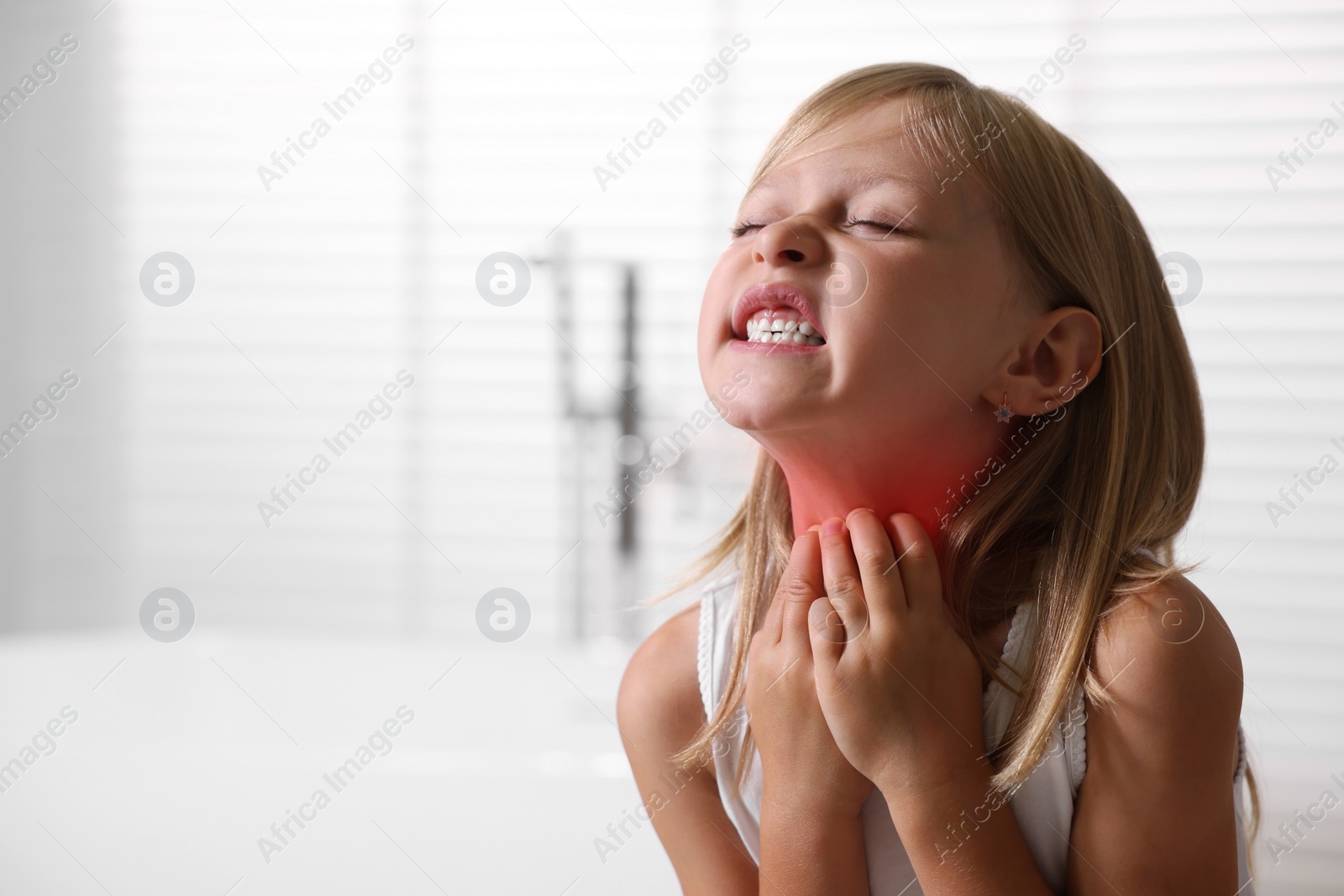 Photo of Suffering from allergy. Little girl scratching her neck indoors, space for text
