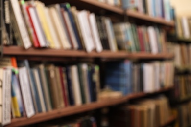 Photo of Blurred view of shelves with books in library