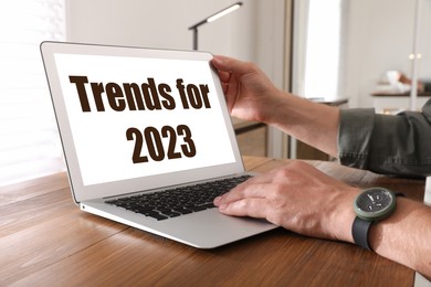 Image of Trends For 2023 text on laptop display. Man using device, closeup