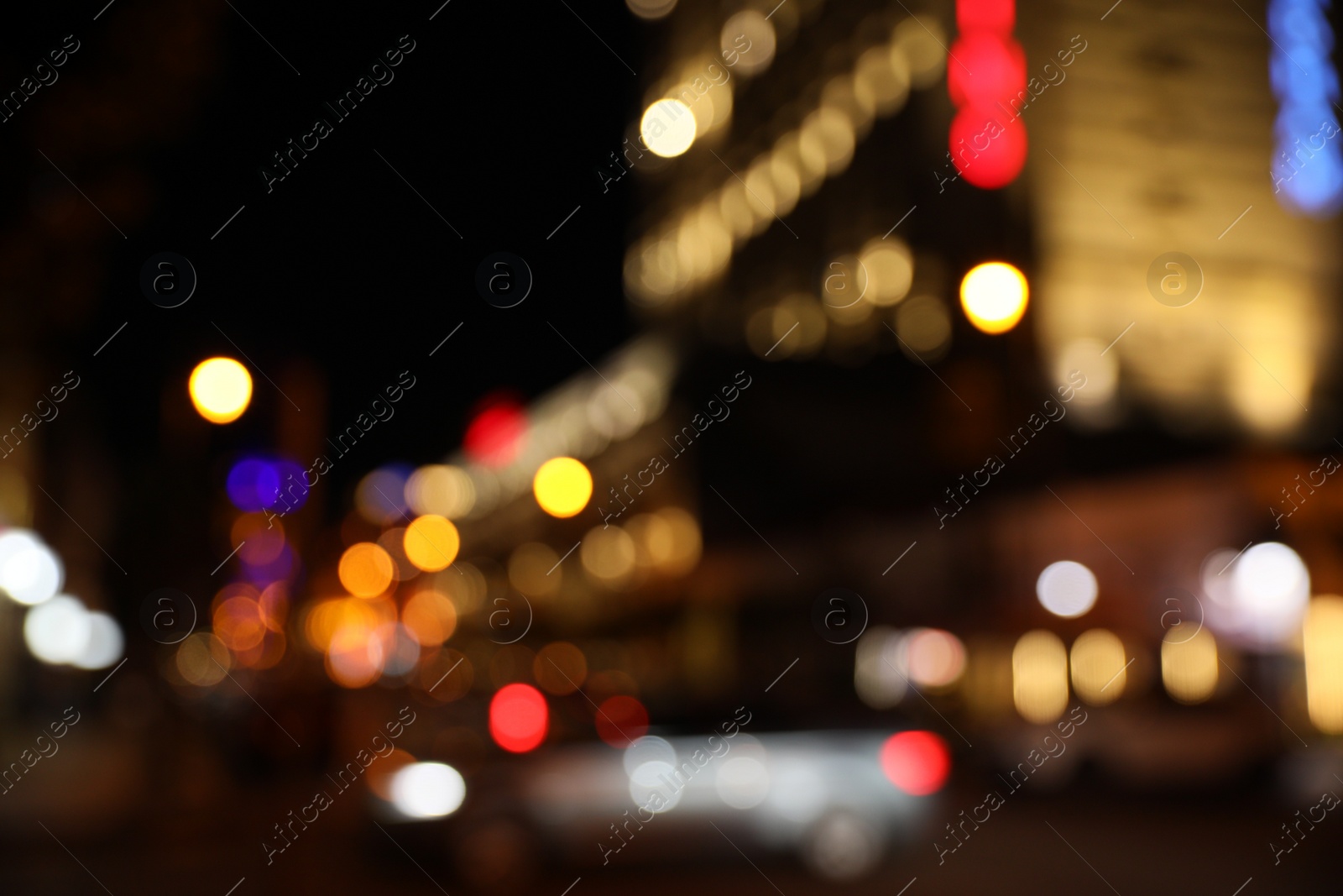 Photo of Blurred view of city street with lights at night. Bokeh effect