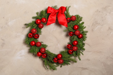 Photo of Beautiful Christmas wreath with festive decor on light wall