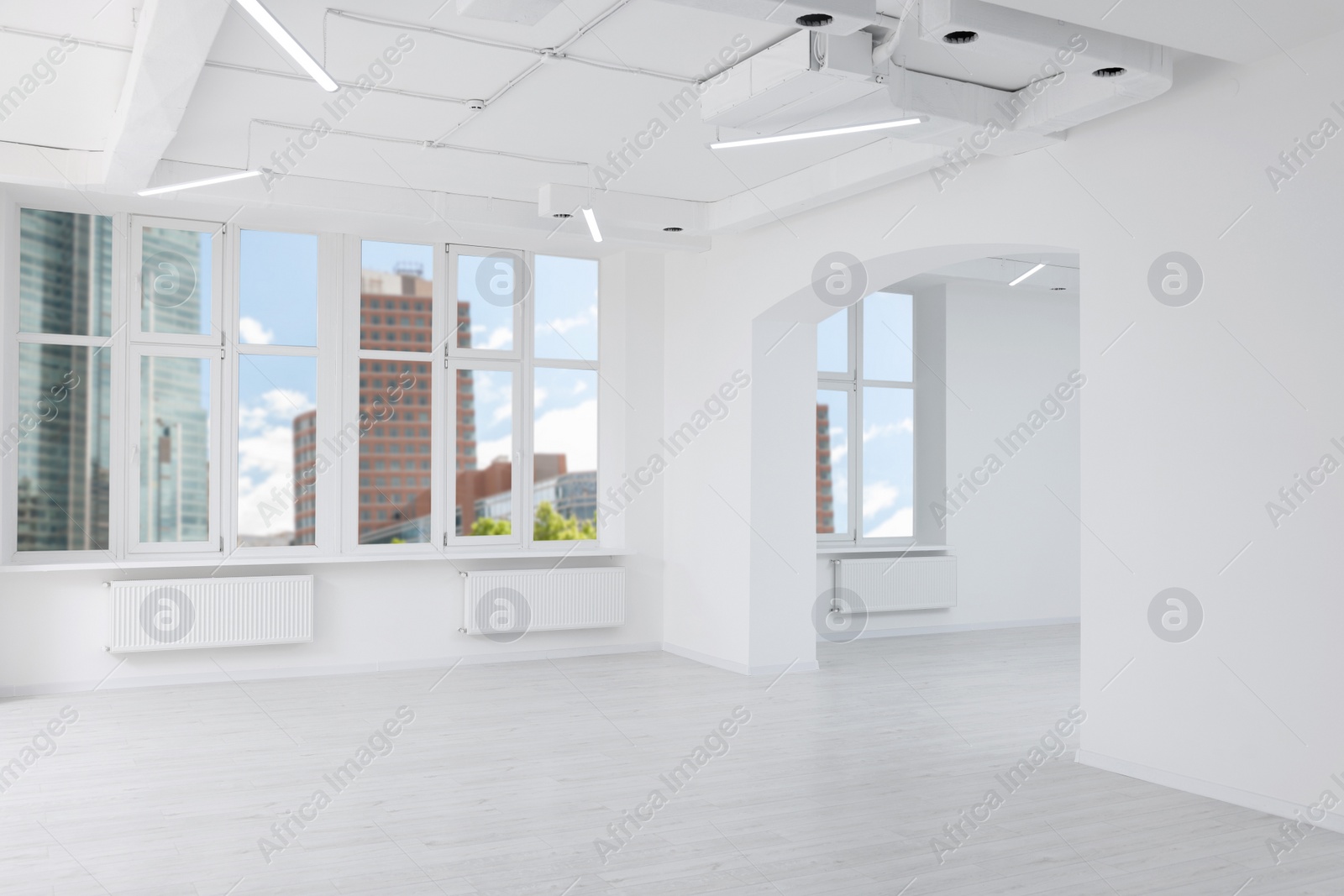 Photo of Empty room with white walls and beautiful windows during repair