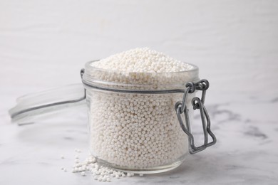 Tapioca pearls in jar on white marble table