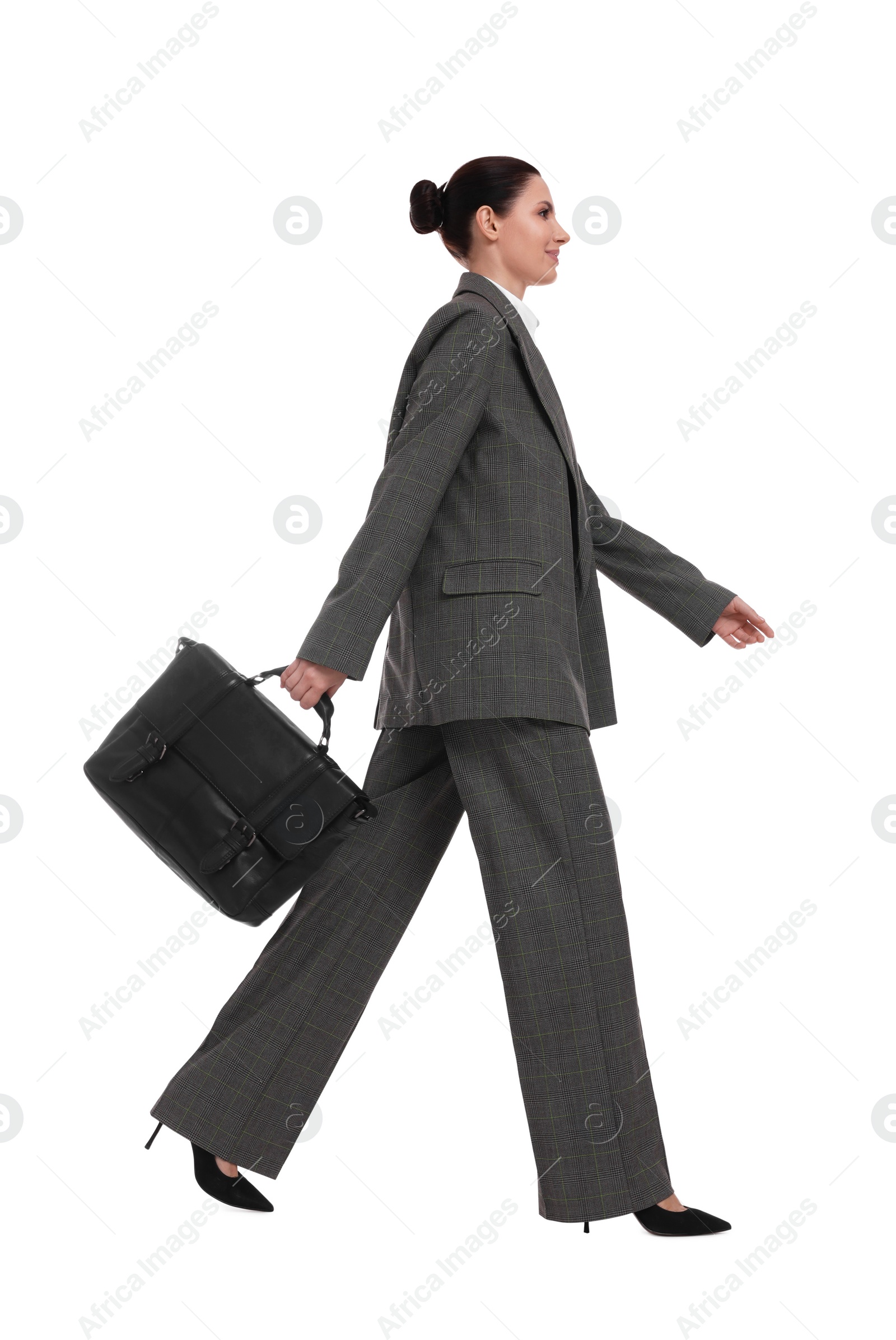 Photo of Beautiful businesswoman in suit with briefcase walking on white background