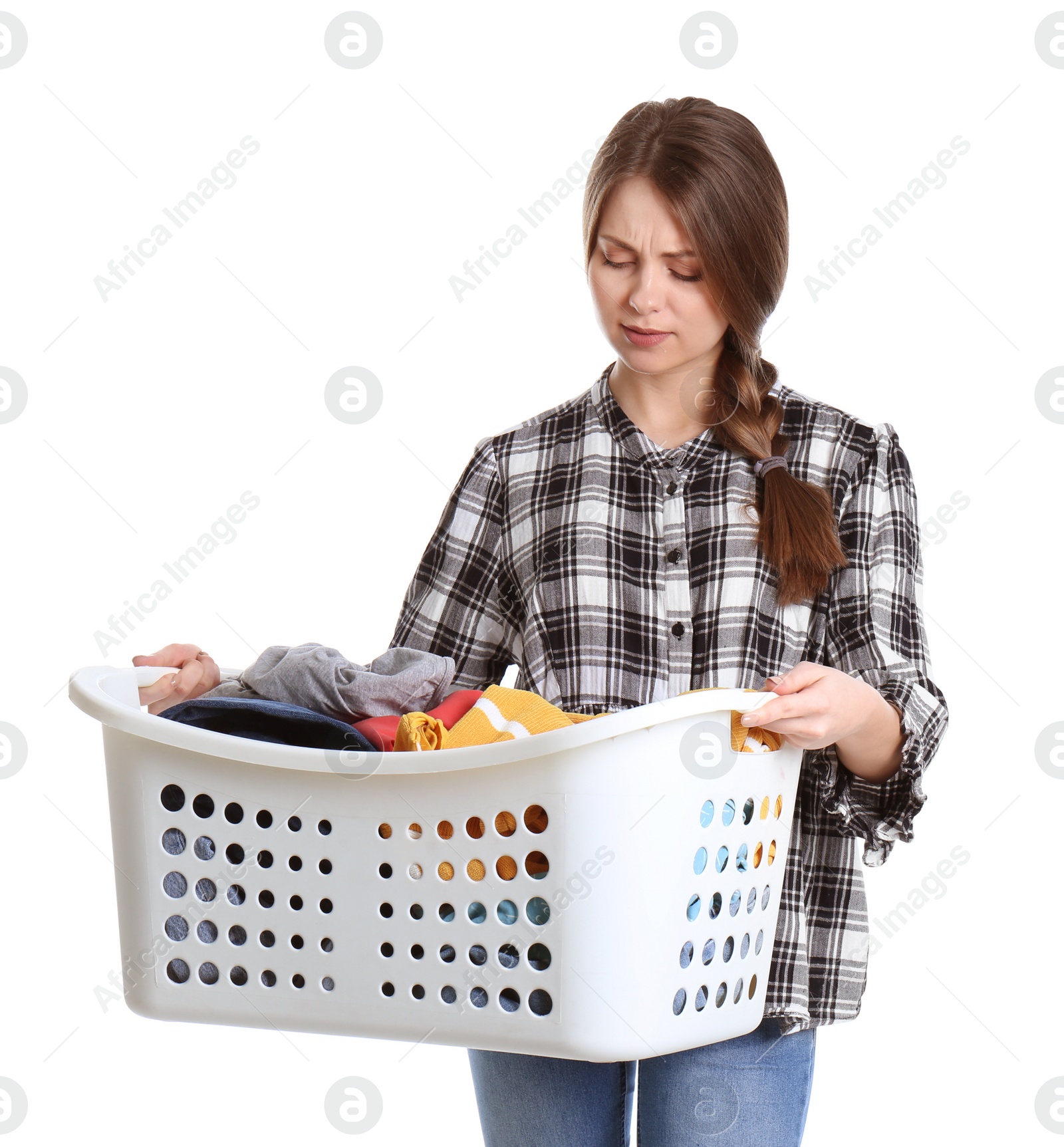 Photo of Displeased young woman holding basket with laundry on white background