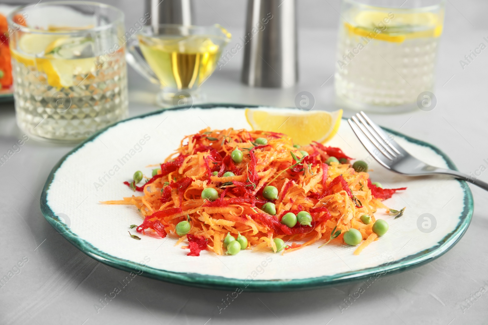 Photo of Tasty salad with fresh carrot on plate