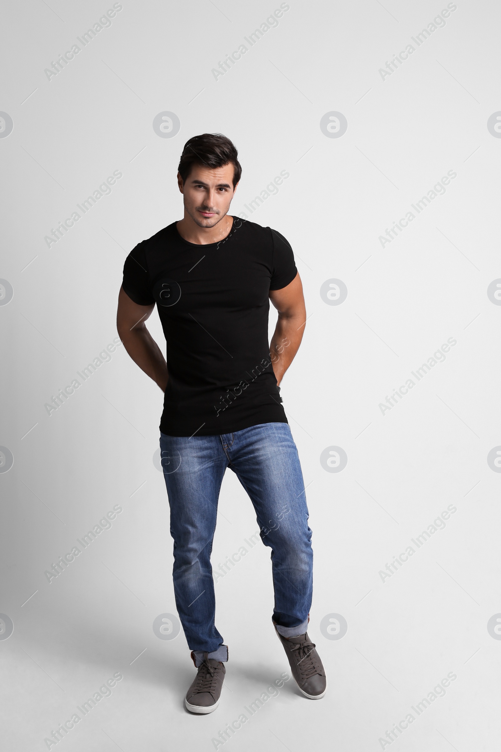 Photo of Full length portrait of handsome young man in casual clothes on grey background