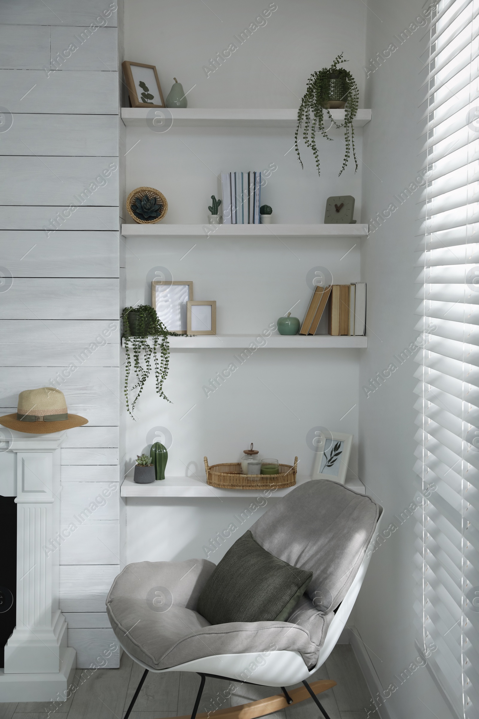 Photo of Many shelves with different decor in room. Interior design