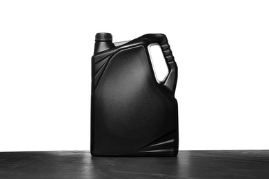 Photo of Motor oil in black canister on table against white background