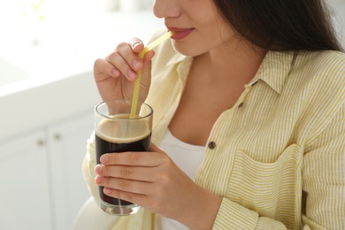 Photo of Young woman with cold kvass indoors, closeup. Traditional Russian summer drink