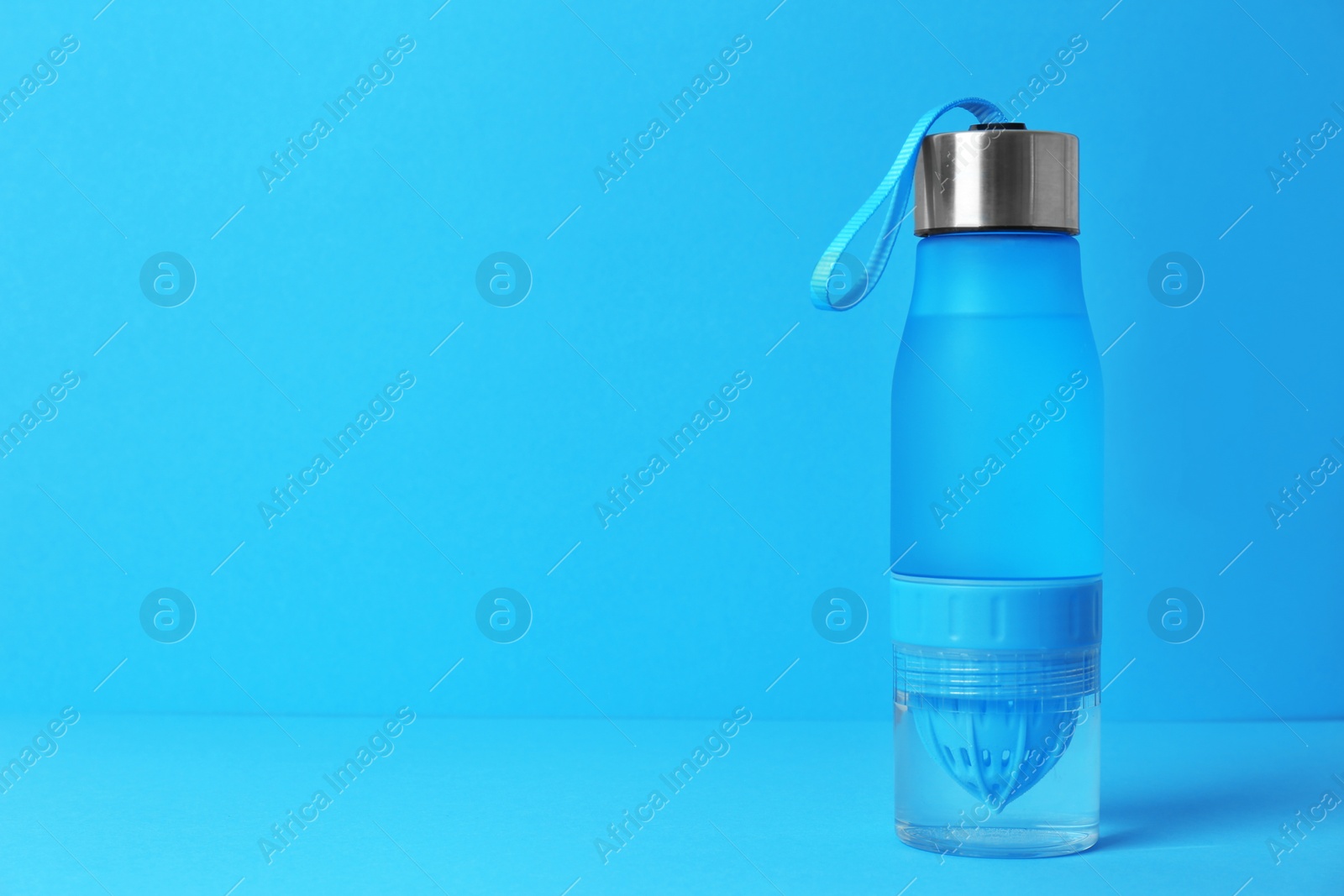 Photo of Sport bottle with space for text on color background