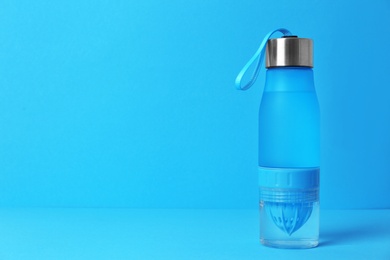 Photo of Sport bottle with space for text on color background