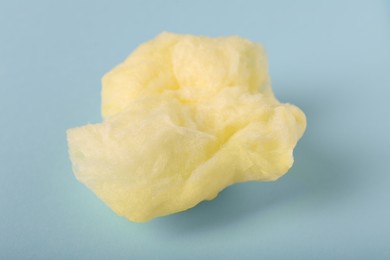 Photo of Sweet cotton candy on light blue background, closeup